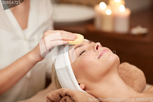 Image of close up of woman having face cleaning in spa