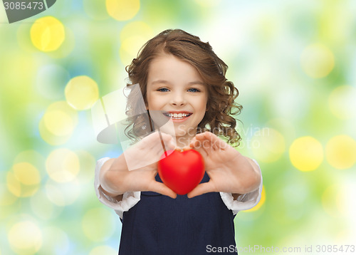 Image of smiling little girl with red heart