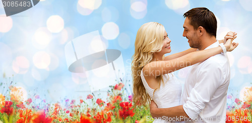 Image of happy couple hugging over natural background