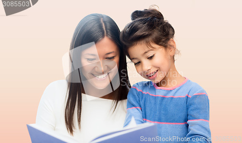 Image of happy mother and daughter reading book