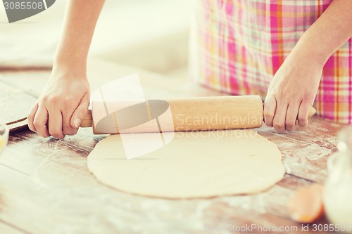 Image of close up of female working with rolling-pin