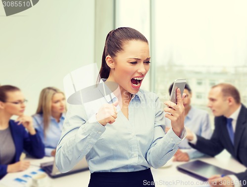 Image of screaming businesswoman with smartphone