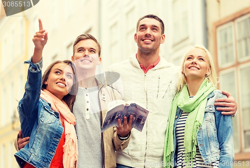 Image of group of friends with city guide exploring town