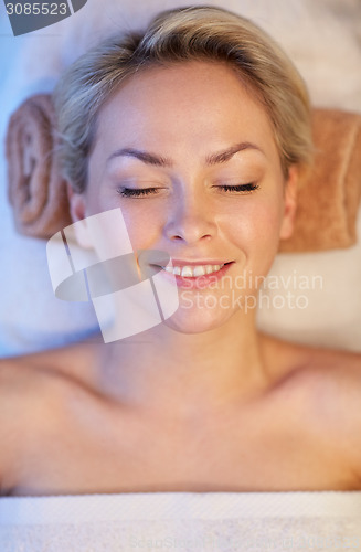 Image of close up of smiling young woman lying in spa