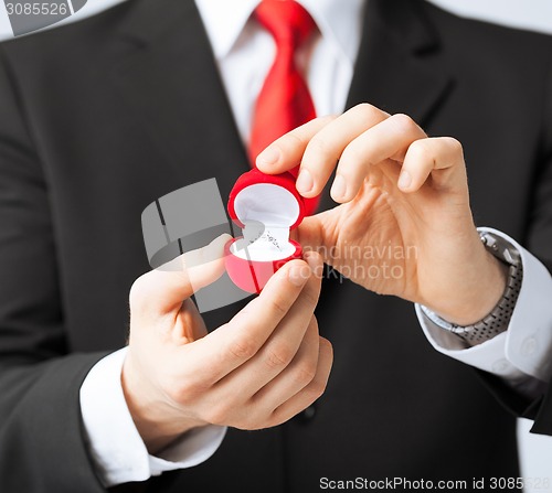 Image of man with wedding ring and gift box