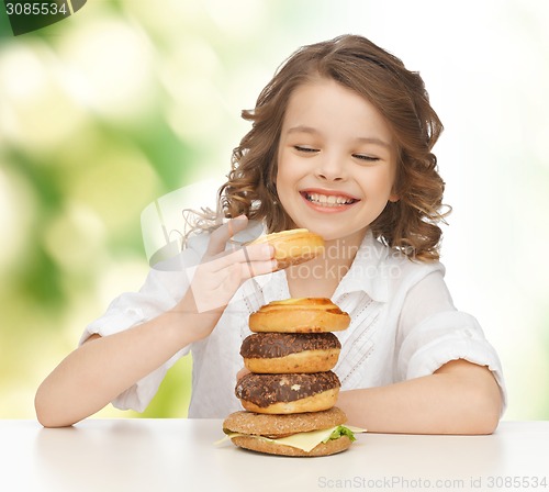 Image of happy smiling girl with junk food