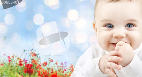 Image of beautiful happy baby over poppy field background