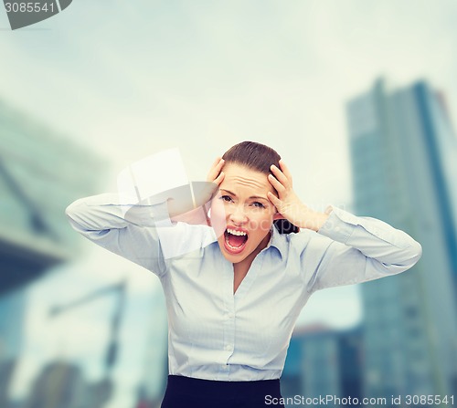 Image of angry screaming businesswoman outdoors