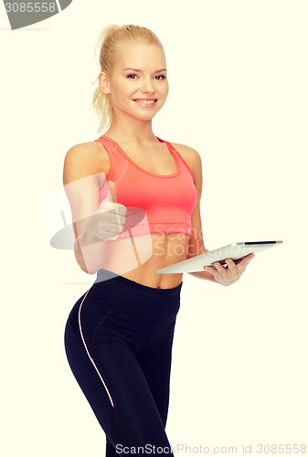 Image of smiling sporty woman with tablet pc computer