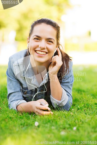 Image of smiling young girl with smartphone and earphones