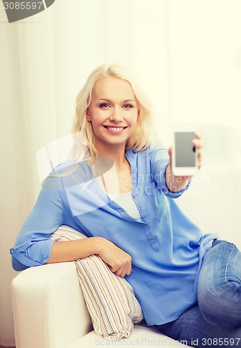 Image of smiling woman with blank smartphone screen at home