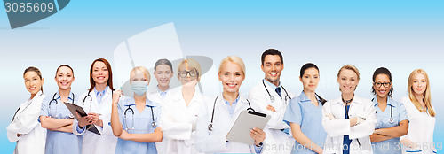 Image of smiling female doctors and nurses with tablet pc
