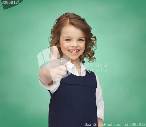 Image of happy little school girl showing thumbs up