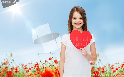 Image of smiling little girl with red heart