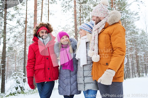 Image of group of smiling men and women in winter forest