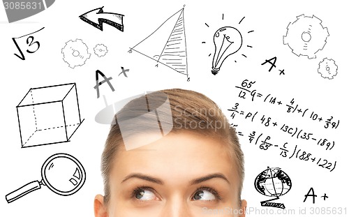 Image of close up of woman looking to mathematical doodles