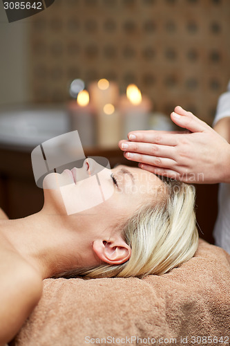 Image of close up of woman having face massage in spa