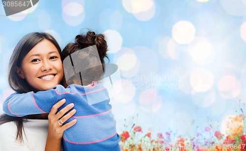 Image of happy mother and daughter hugging