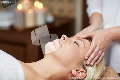 Image of close up of woman having face massage in spa