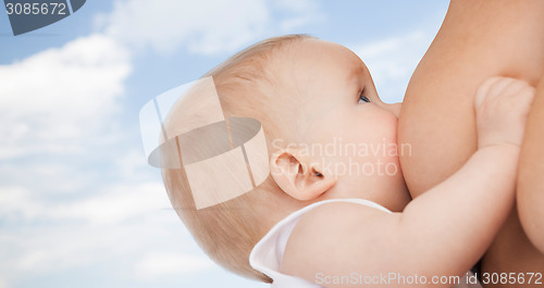 Image of close up of mother breast feeding adorable baby