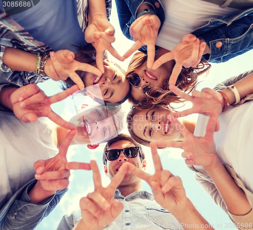 Image of group of teenagers showing finger five