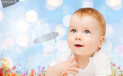 Image of beautiful happy baby over poppy field background