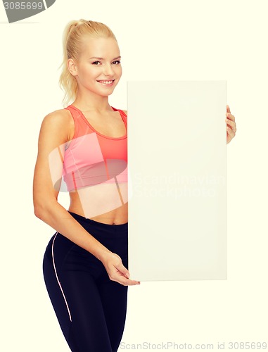 Image of smiling sportswoman with white blank board