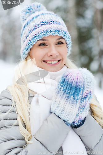 Image of smiling young woman in winter forest