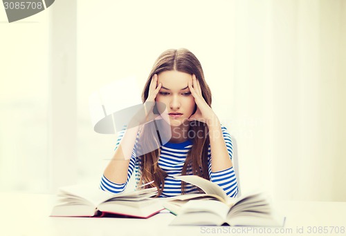 Image of stressed student girl with books