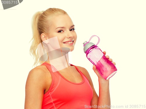 Image of smiling sporty woman with water bottle