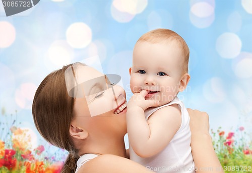 Image of happy mother with baby over natural background