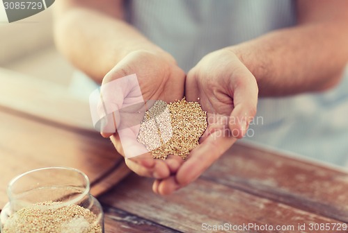 Image of cloes up of male cupped hands with quinoa