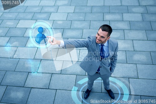 Image of young smiling businessman outdoors from top