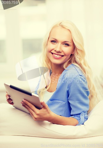 Image of smiling woman with tablet pc computer at home