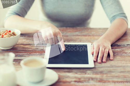 Image of woman pointing finger to tablet pc computer