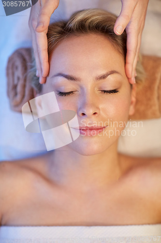 Image of close up of woman having face massage in spa