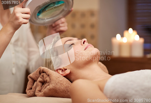 Image of close up of young woman lying in spa