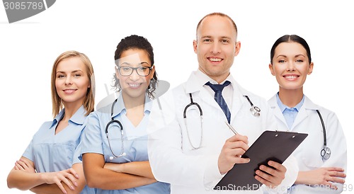 Image of group of smiling doctors with clipboard