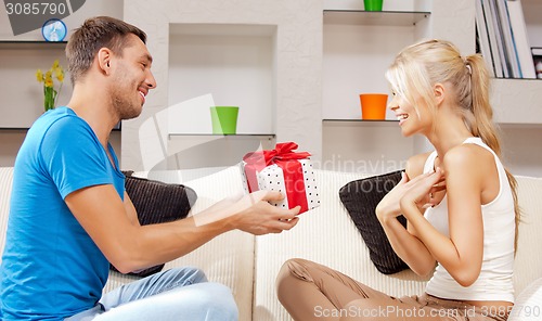 Image of happy romantic couple with gift