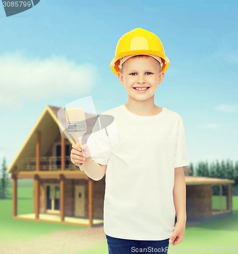 Image of smiling little boy in helmet with paint brush