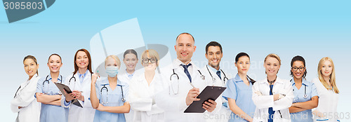 Image of group of smiling doctors with clipboard