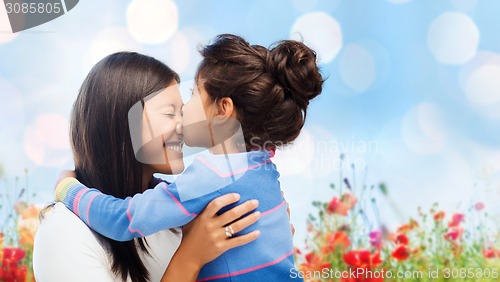 Image of happy little girl hugging and kissing her mother