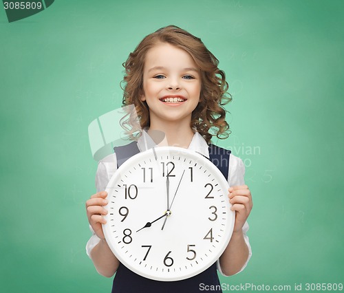 Image of smiling girl holding big clock