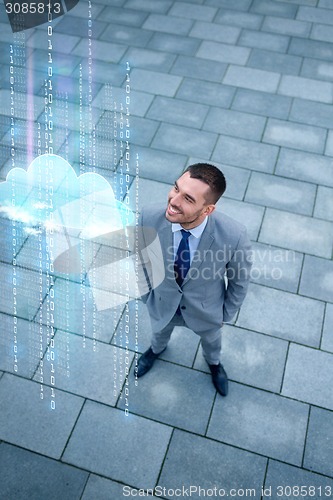 Image of young smiling businessman outdoors from top