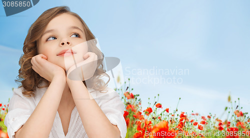 Image of beautiful girl sitting at table and looking up