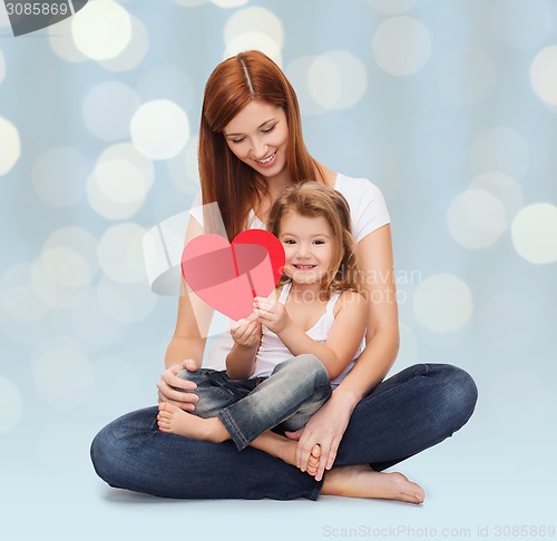 Image of happy mother with little girl holding red heart