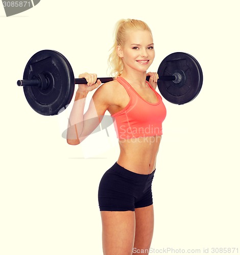 Image of smiling sporty woman exercising with barbell