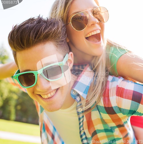 Image of smiling couple having fun in park