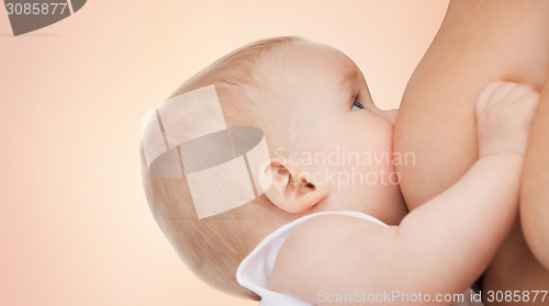 Image of close up of mother breast feeding adorable baby