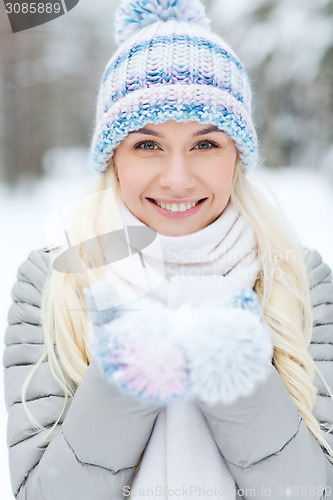 Image of smiling young woman in winter forest